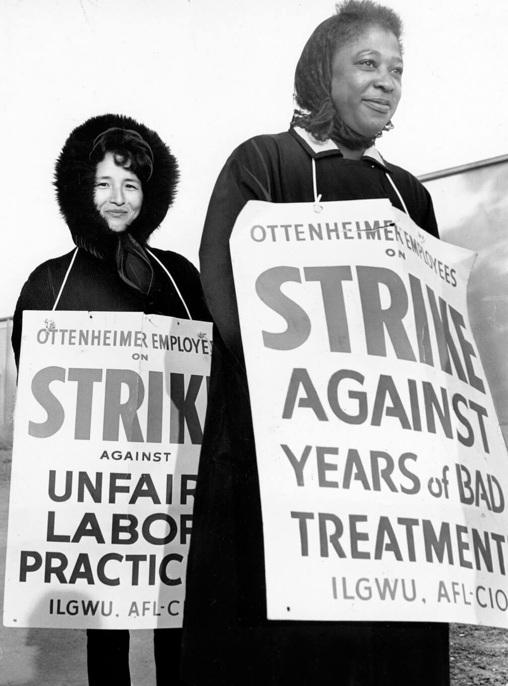 Two women holding signs that say Strike Against Years of Bad Treatment