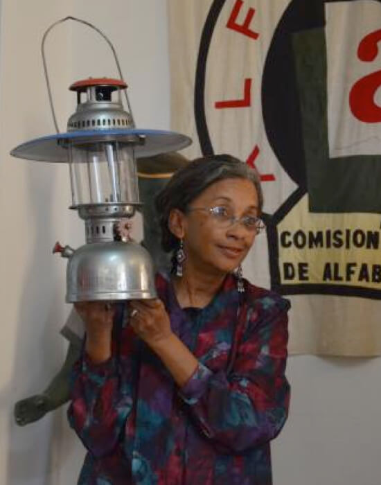 Literacy Museum Director Luisa Yara Campos shows us one of the oil lamps that lit the tutoring session by the Cuban literacy volunteers in the countryside.