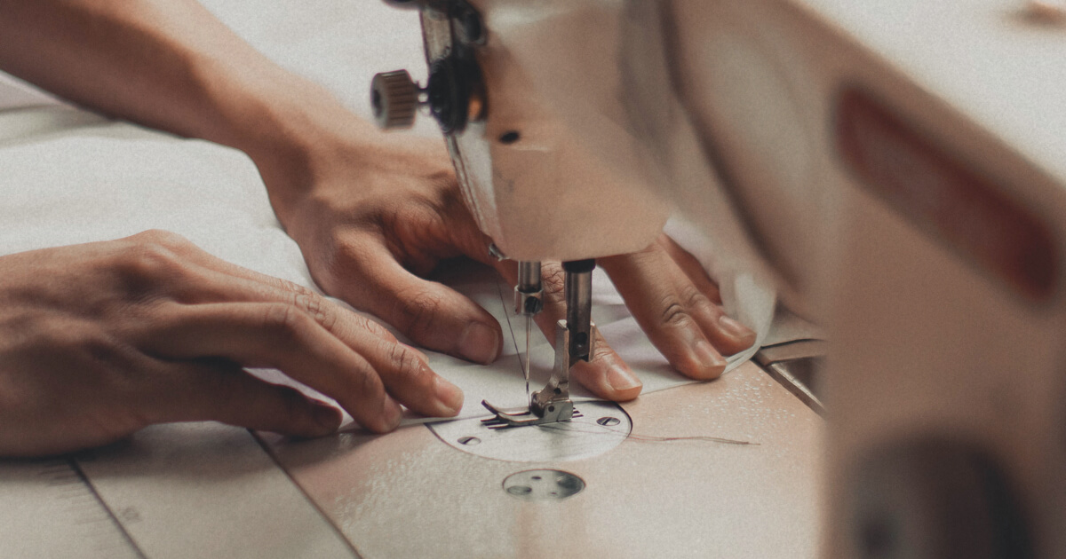 Close-up of hands sewing.
