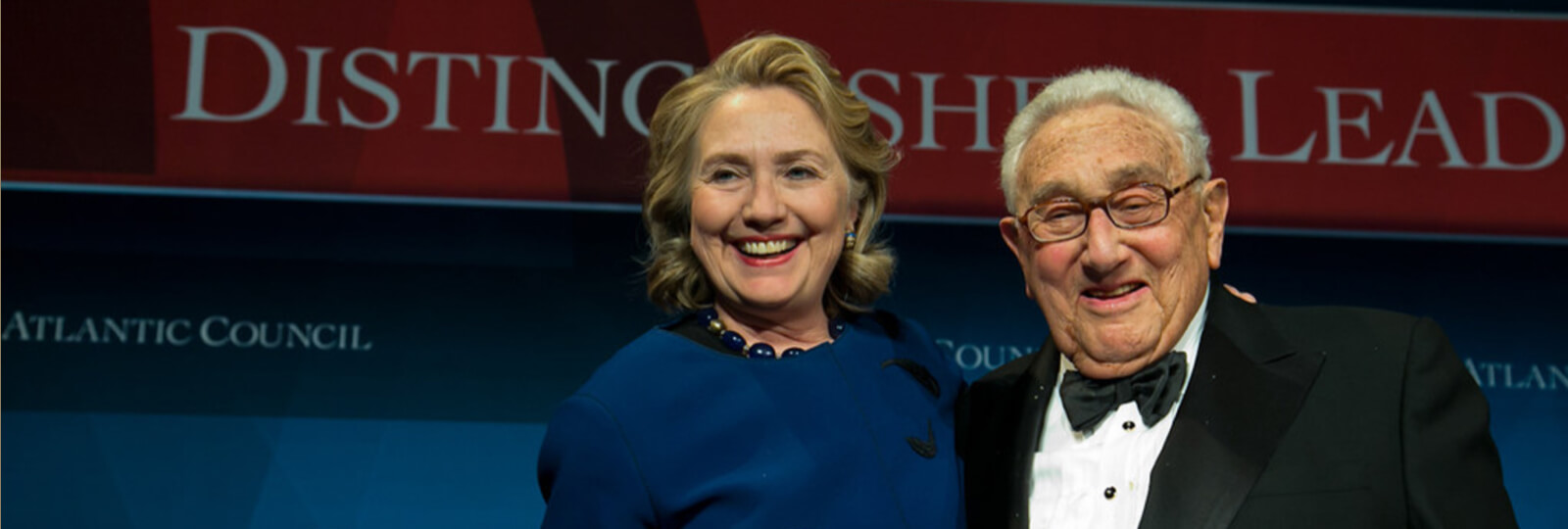 Hillary Clinton stands beside Henry Kissinger