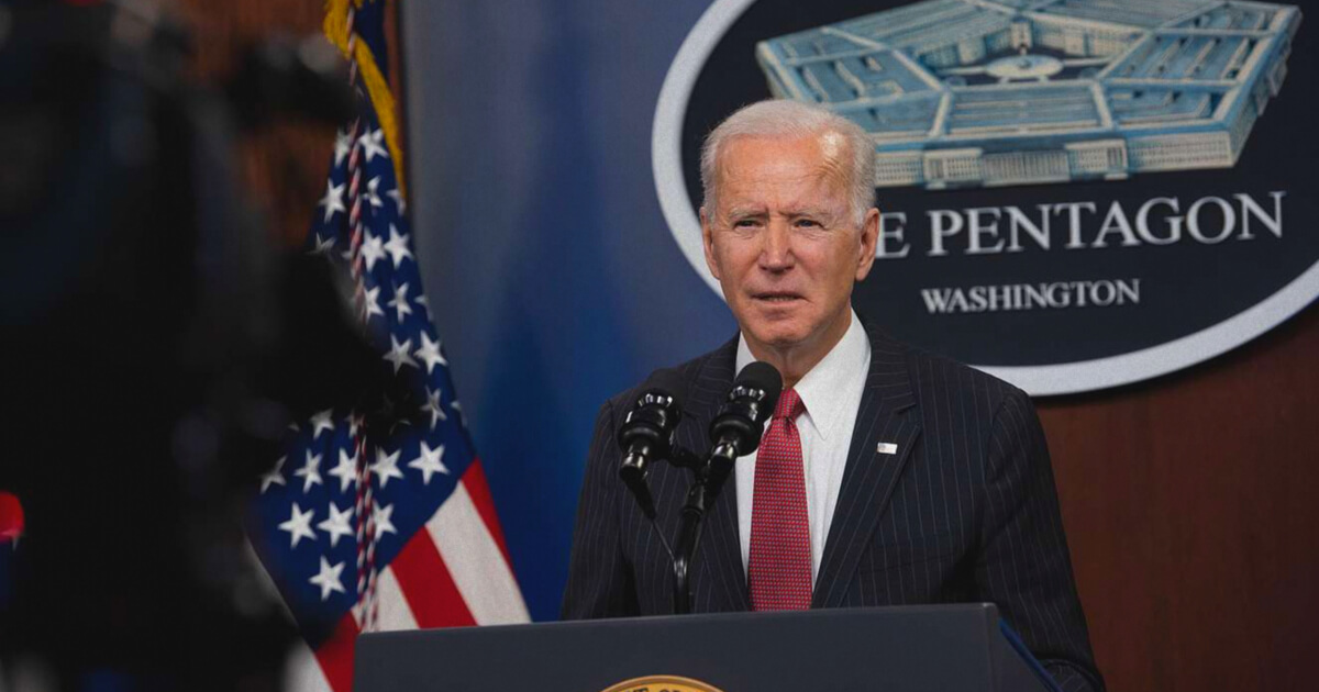 Joe Biden speaks in front of a Pentagon sign