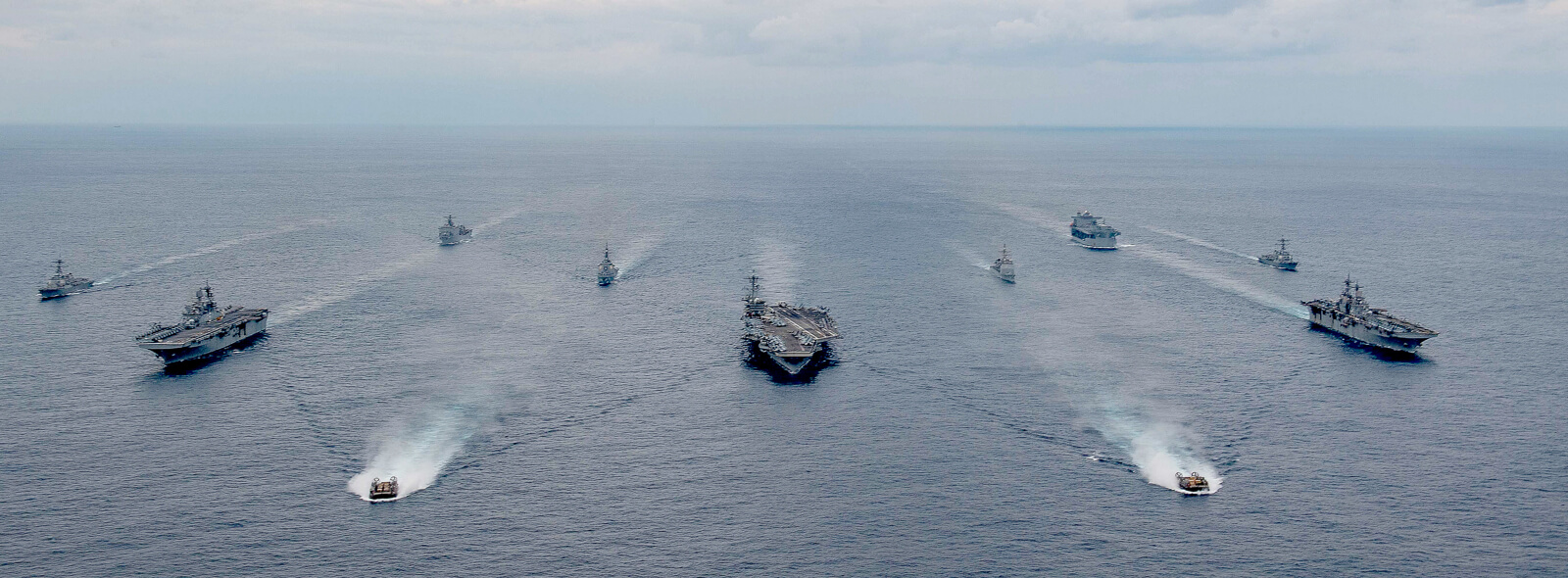 Ships of the America and Essex Amphibious Ready Groups, and Carrier Strike Group (CSG) 3, sail in formation in the Philippine Sea