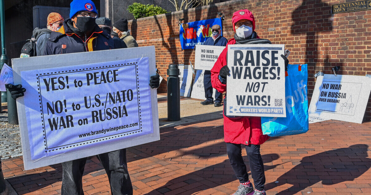 Anti-war protesters holding signs